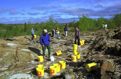 Knight North area in 2001 people spreading limestone on the rocky and barren ground